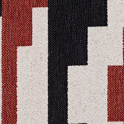 A sample of a flat woven fabric from the Boho Chic Collection with black, red and white patterns.
