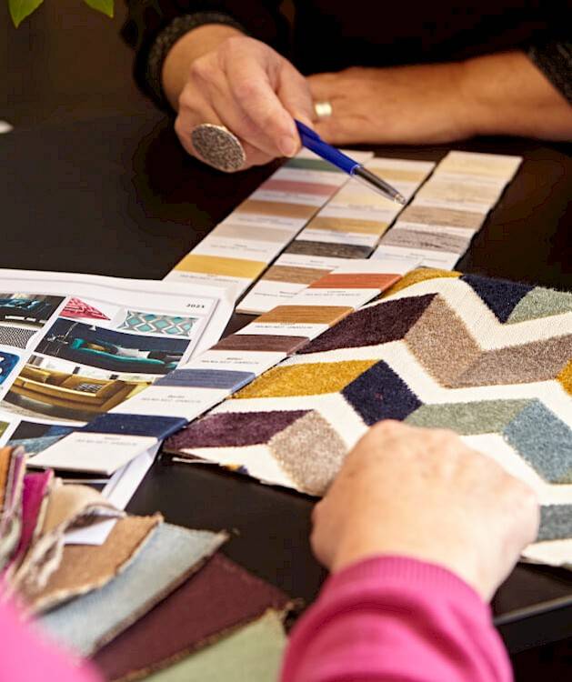 people discussing and selecting fabrics at table