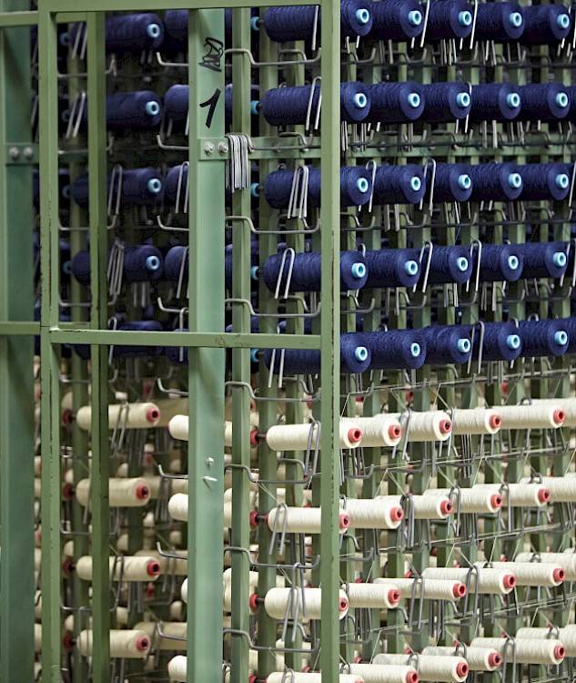 blue and white threads on weaving loom