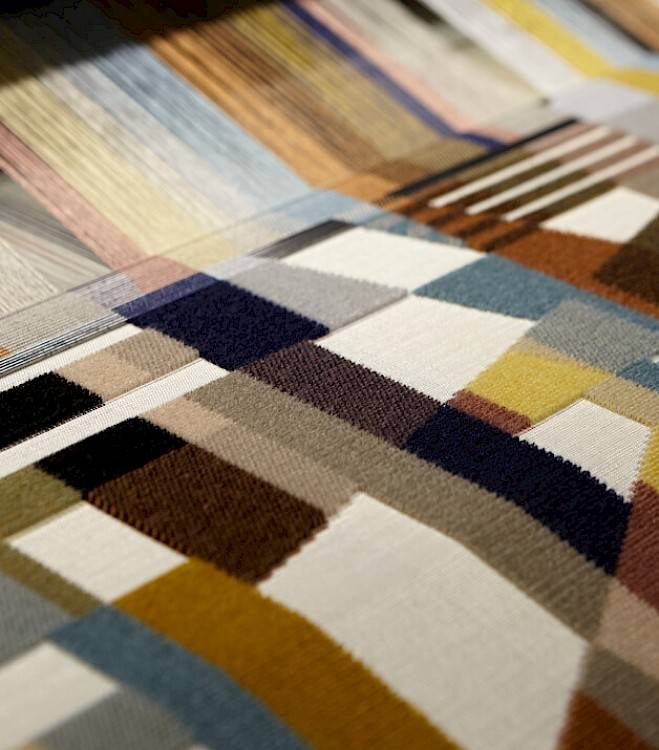 Jacquard velvet loom in process of weaving colourful pattern